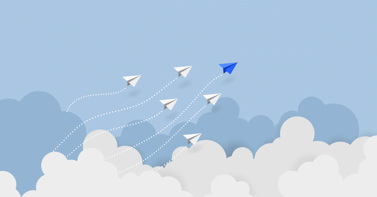 A soft blue background. White clouds come up from the bottom of the image with blue-gray clouds behind the white clouds. Six paper airplanes fly in a pyramid formation above the clouds. The top paper airplane is blue, the other paper airplanes are white