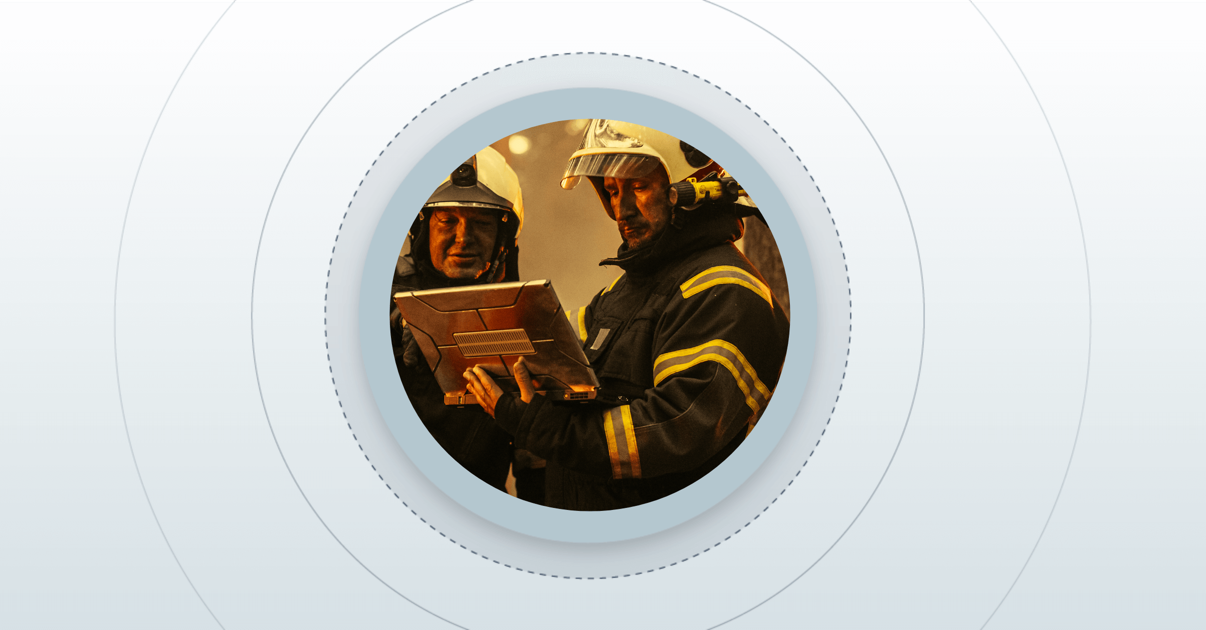 two fire fighters working on a laptop together