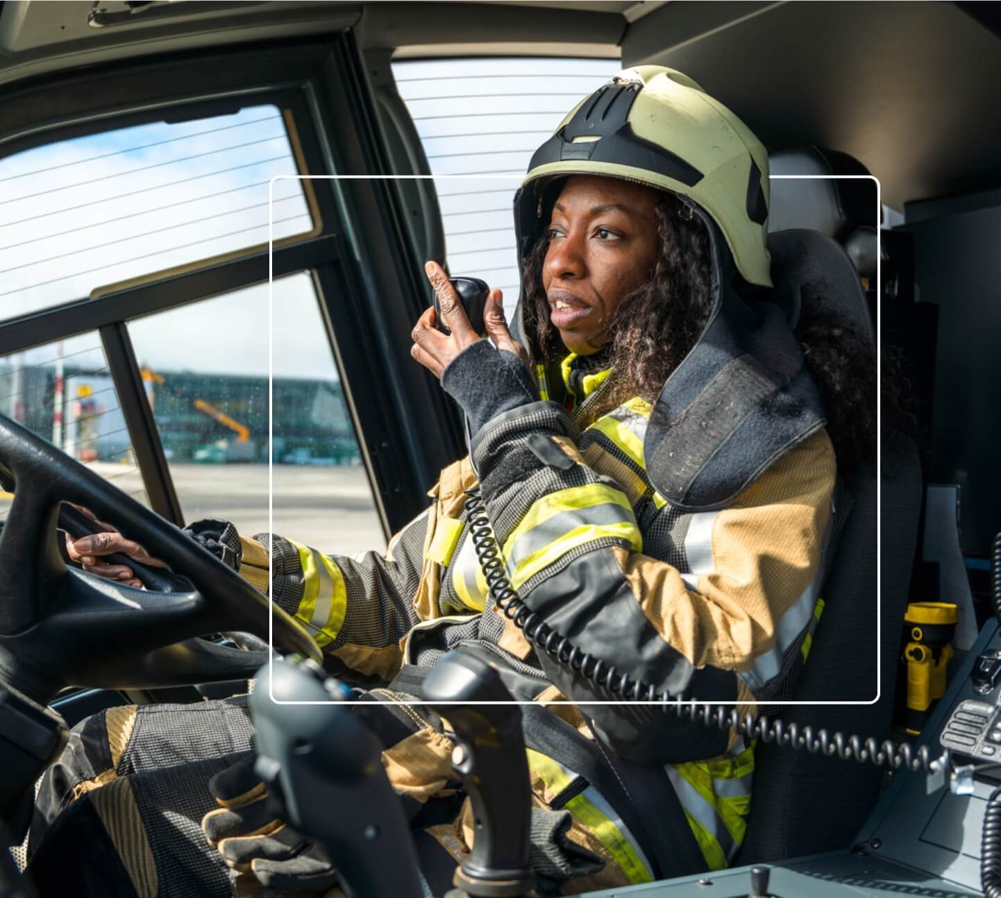 On-duty firewoman speaking to dispatch through vehicle radio