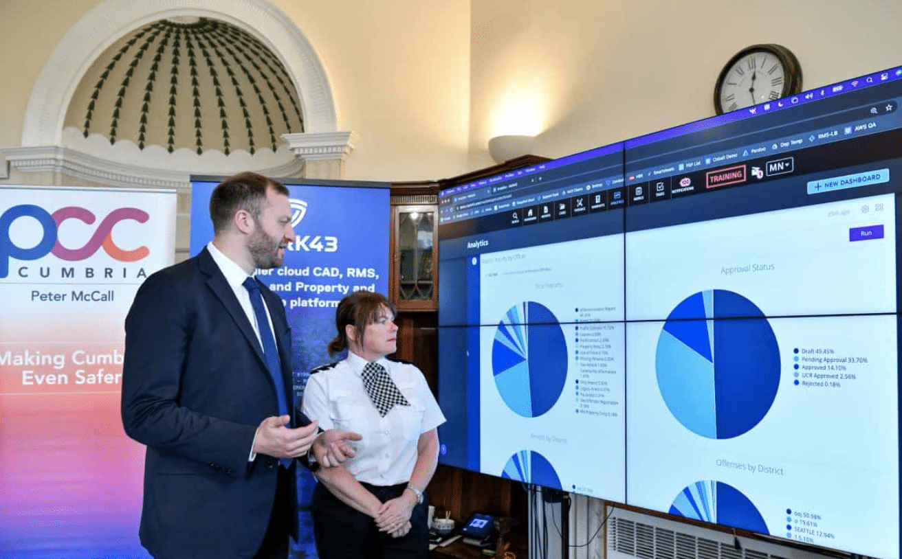 Mark43 team member talking with chief constable and looking at a giant screen