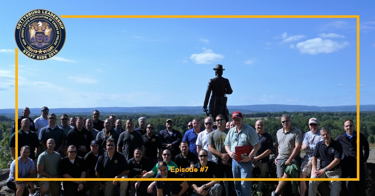 group photo in front of a big brass statue